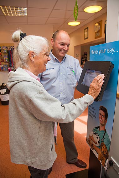 Photo of customers using touchscreen machine